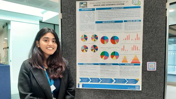 Kimberly Tellis stood next to her award-winning poster
