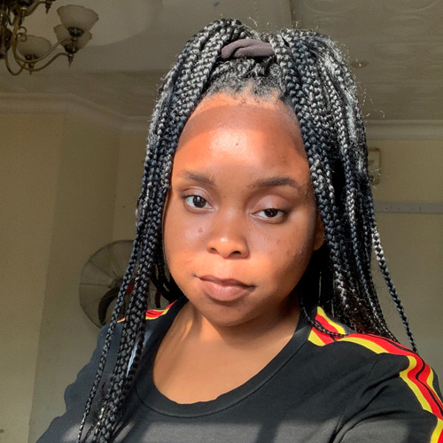 a selfie of a student wearing a black tshirt with stripes