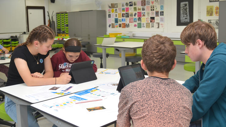 Young students use iPads to determine whether media stories are real or fake.