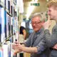 Staff member helping student in the library