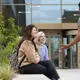 Students sat on a bench outside the student centre at our Preston campus