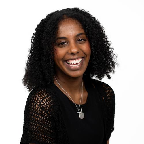 Headshot of Sasha Wiltshire smiling at the camera.