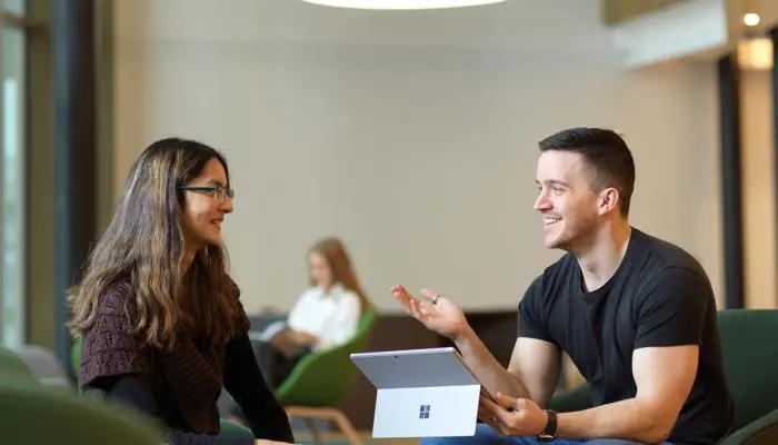 A student talking to a member of staff in the Student Centre