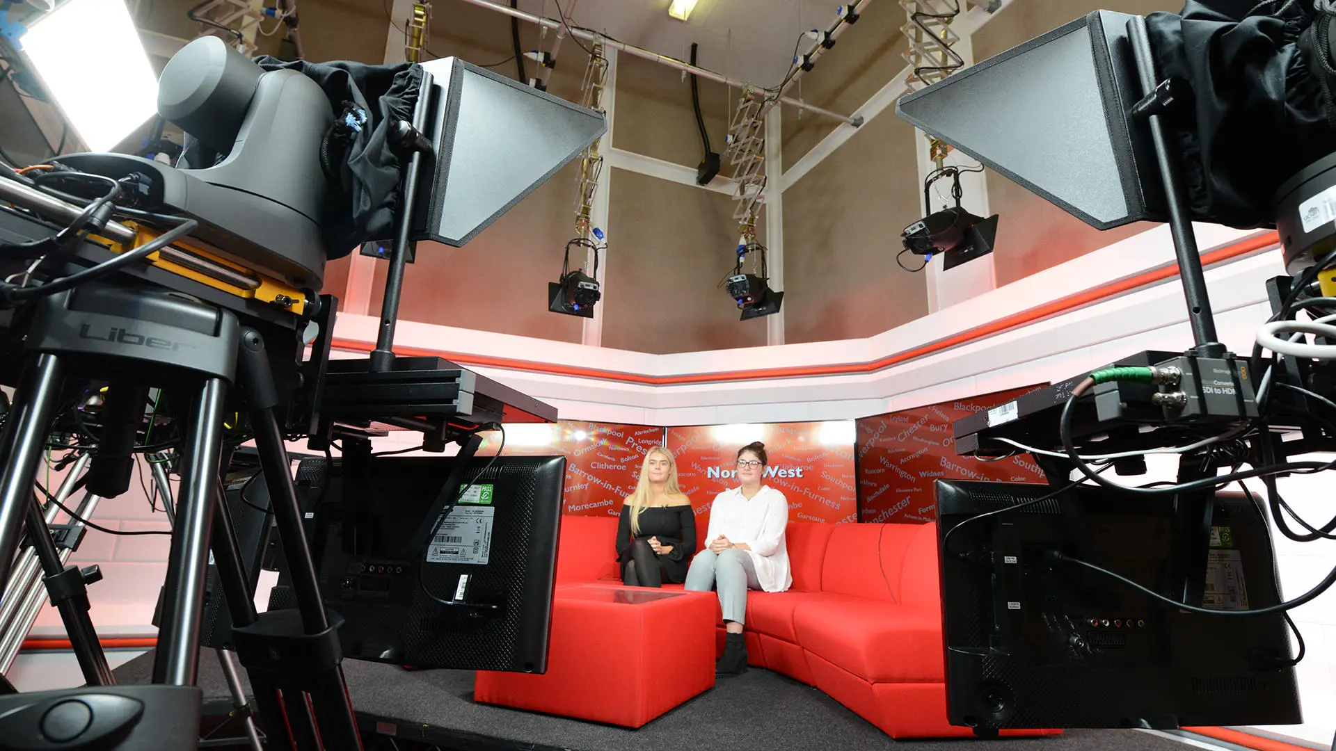 journalism students sat in a news studio