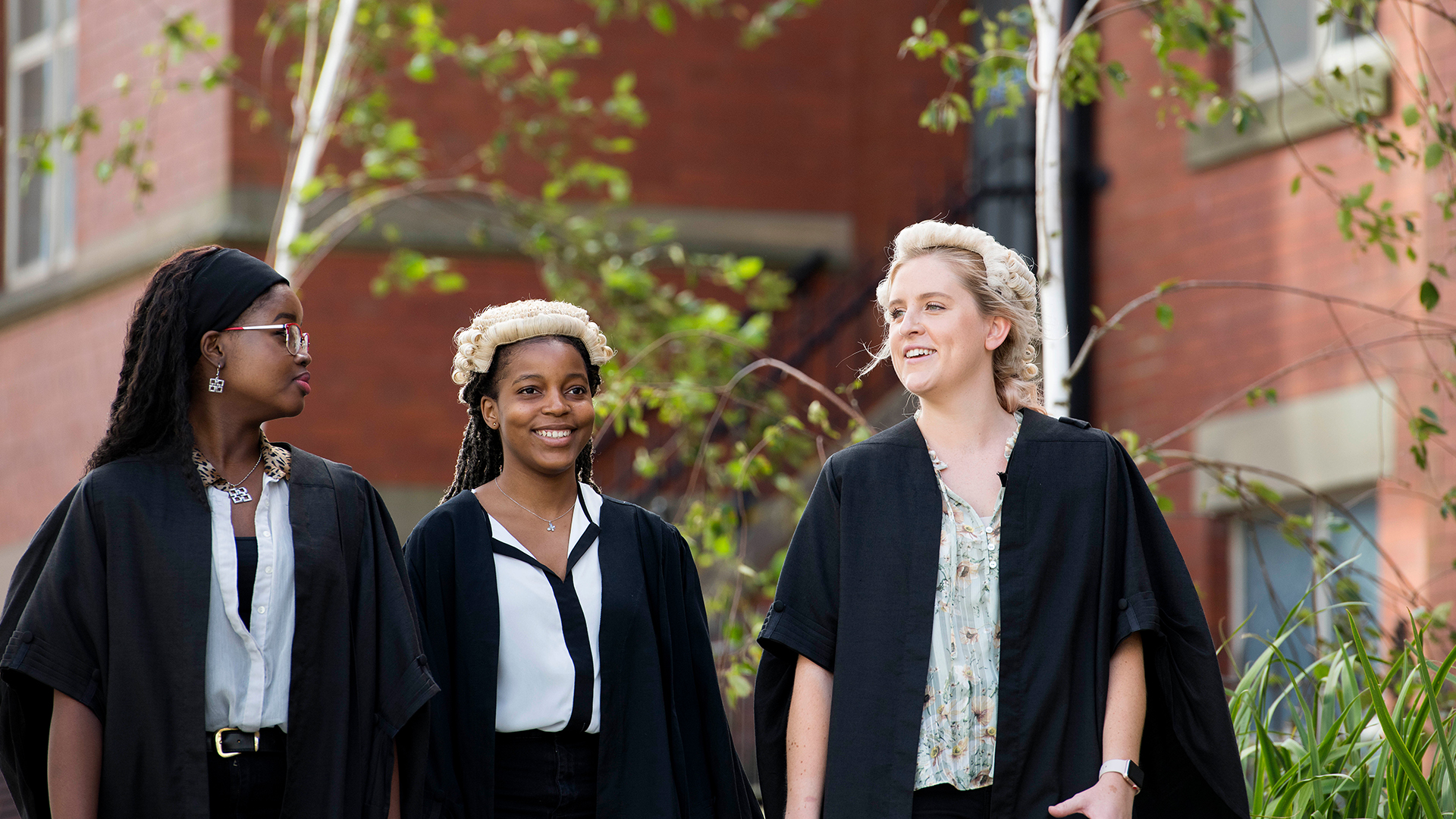 students smiling in gowns
