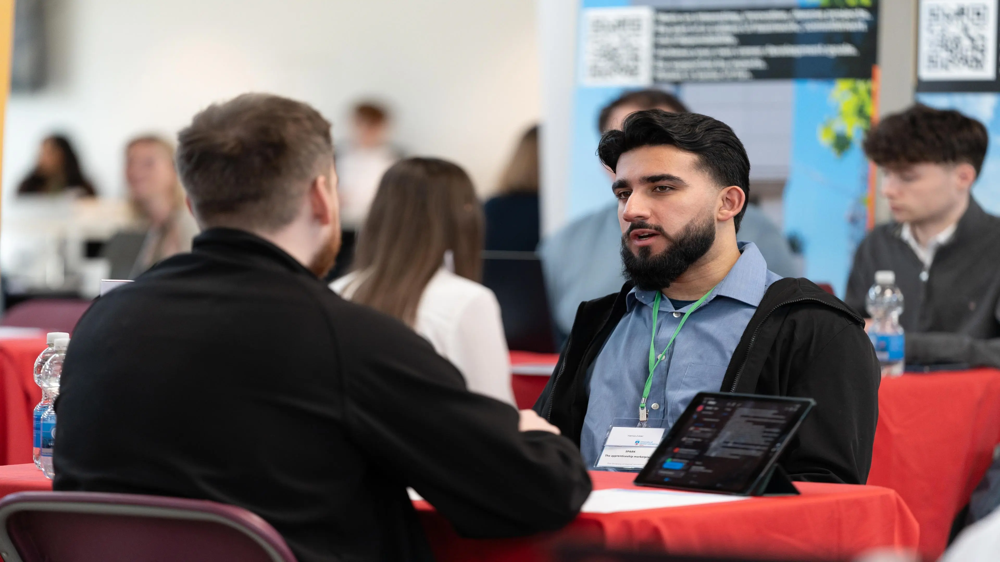 A learner speaks to an employer at a SPARK event