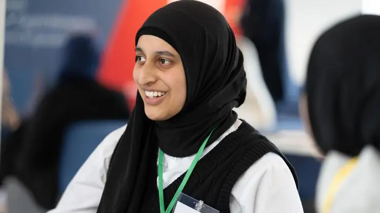 A learner smiles while in a conversation at SPARK.