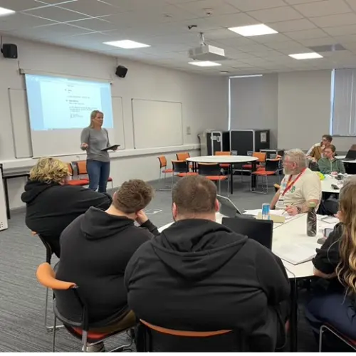 Students in a classroom with a presenter at the front