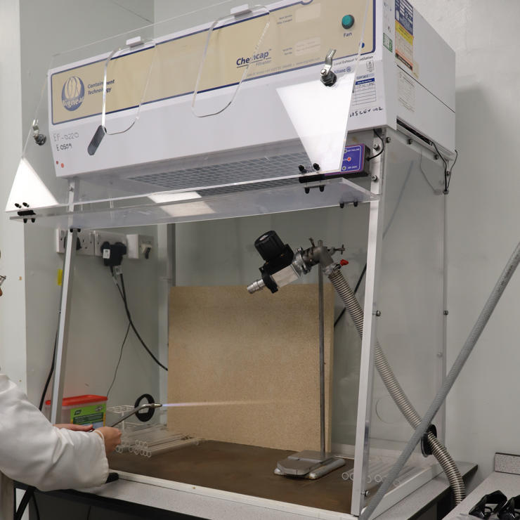 Student sealing a quart ampoule using hydrogen-oxygen torch in the Synthetic Quantum Materials Laboratories