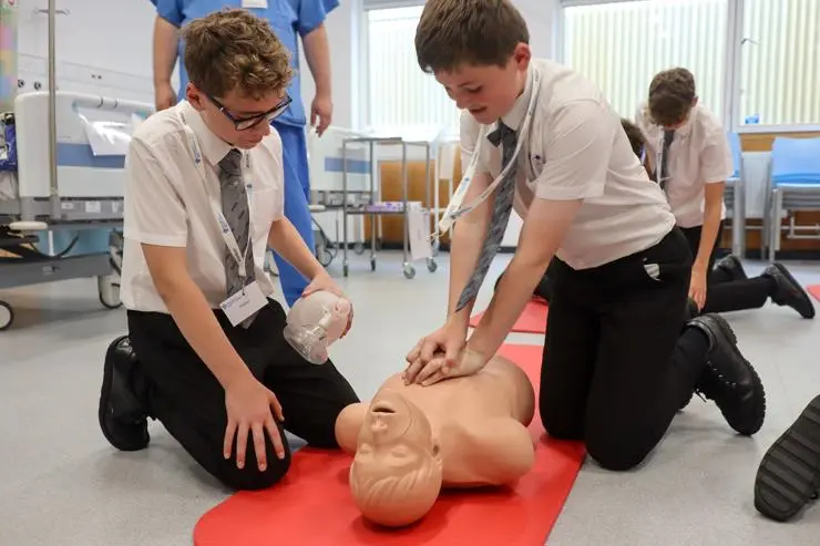Pupils getting hands on with CPR in the simulated children's ward.