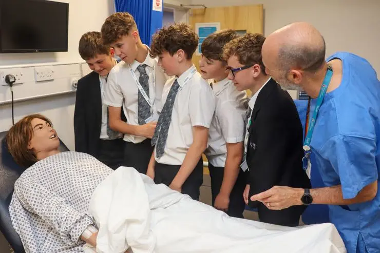 Senior Nursing Academic David Stein shows students a mannikin used for learning