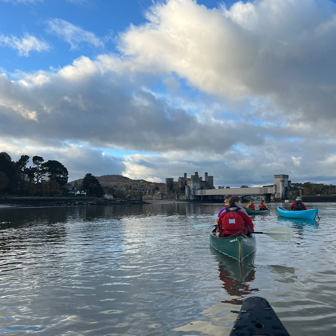 Students canoeing on a lake