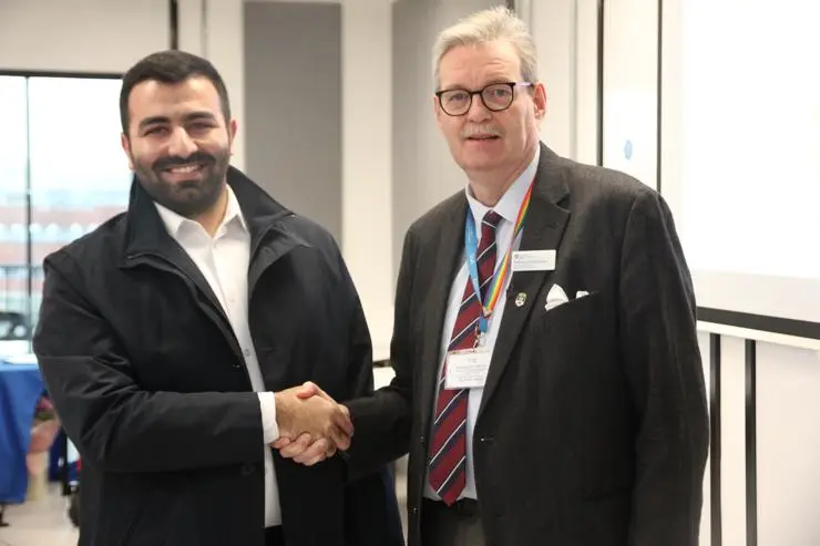Ahmad being congratulated by Professor StJohn Crean at the Research and Knowledge Exchange Festival 