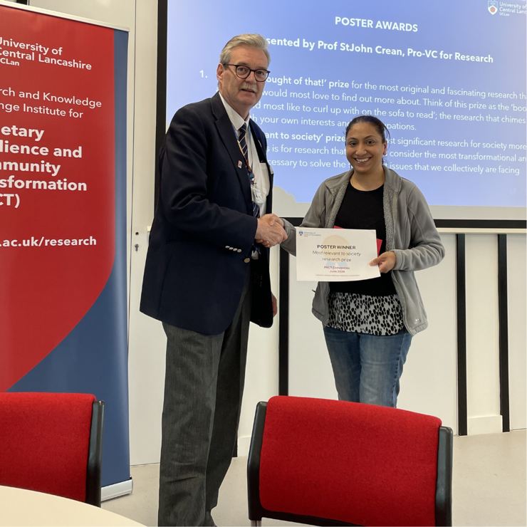 Professor StJohn Crean gives Suntoah Kaur a poster prize certificate