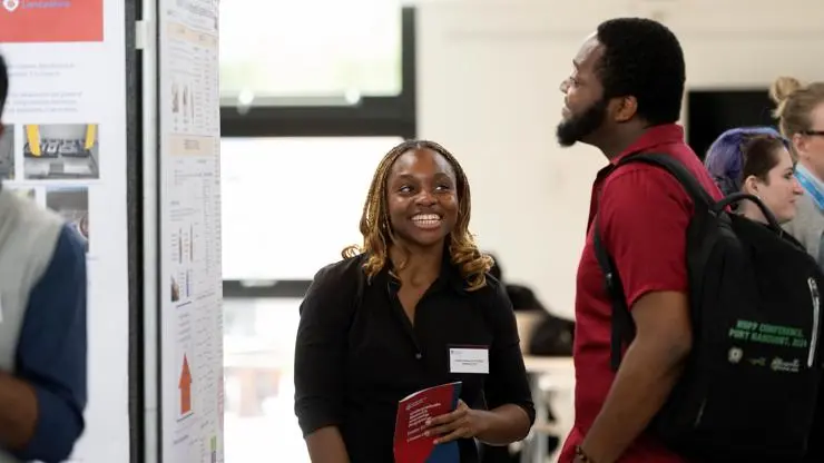 Student research intern, Isobel stands infront of her research poster