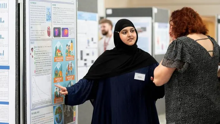 Third prize winner, Kinza Ramzan, presents infront of her award-winning research poster.