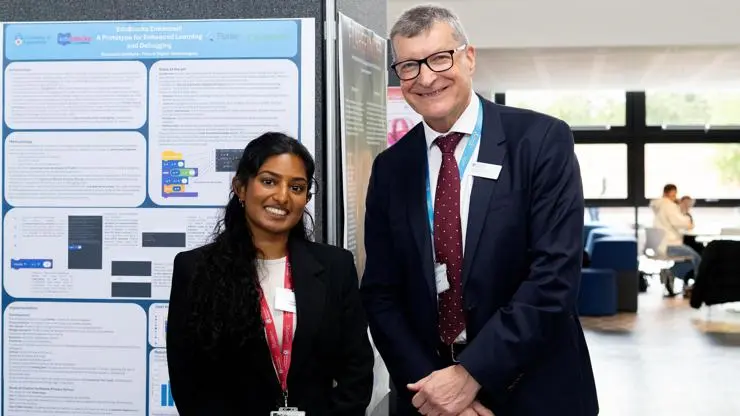 Sitara Lewis, second prize winner, stands next to Vice-Chancellor Professor Graham Baldwin