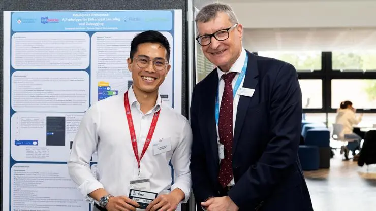Bryan Lee, first prize winner stands next to Vice-Chancellor Professor Graham Baldwin