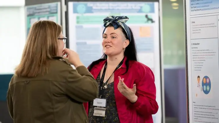 Hannah Wilton, highly commended talks to an attendee.