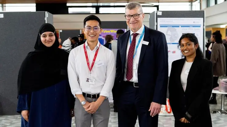 Vice-Chancellor Professor Graham Baldwin stands next to the student research intern winners.