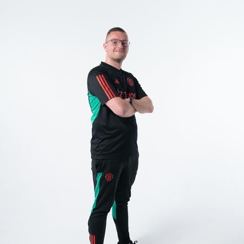 Finn O'Leary standing with arms crossed.