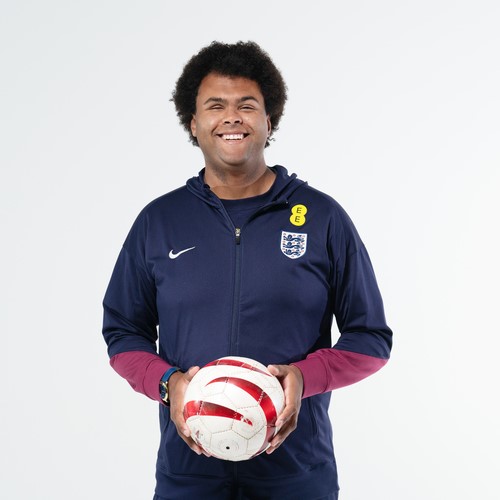 Rainbow Mbuangi holding a football.