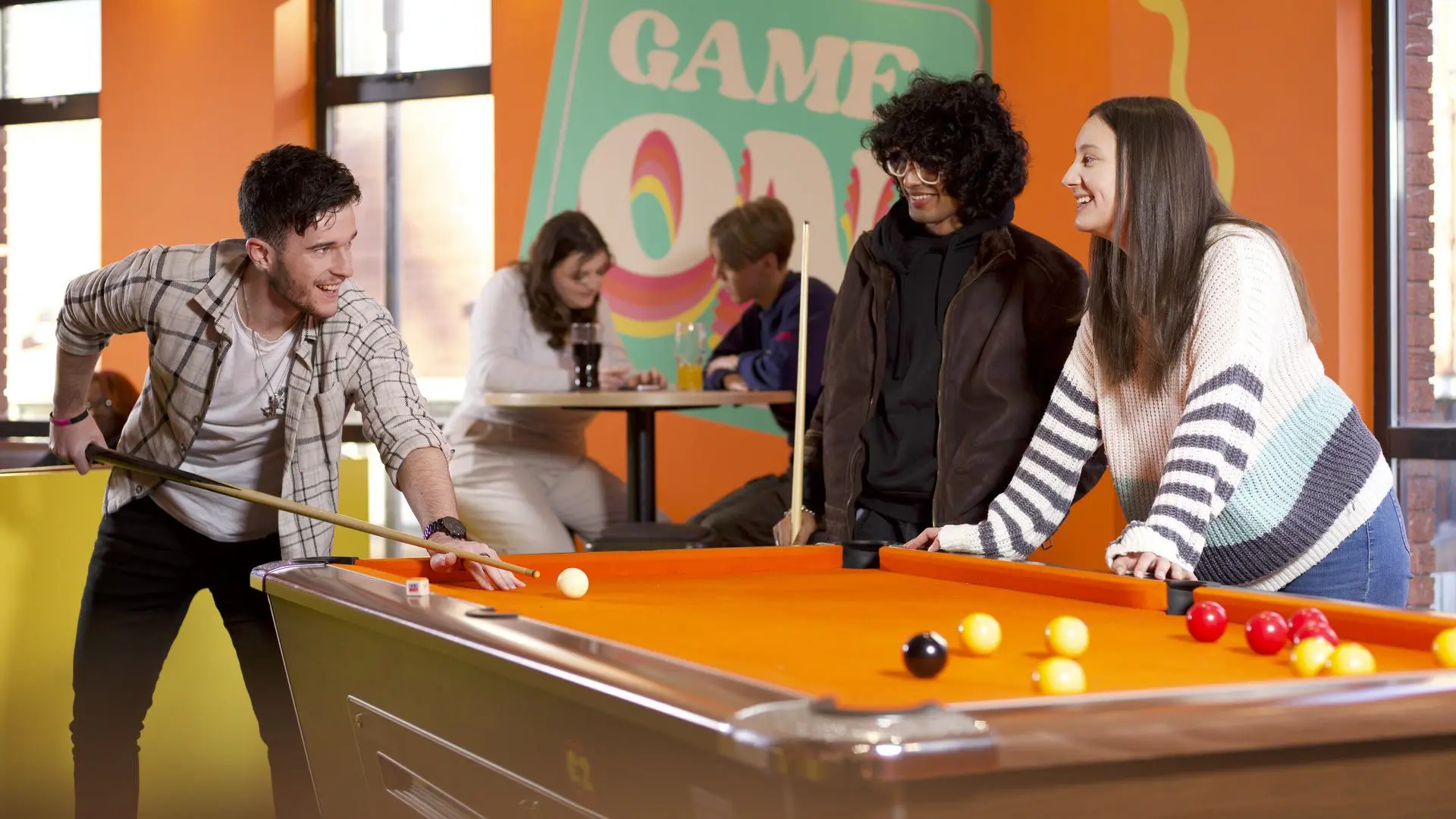 Students playing pool at Lampworks