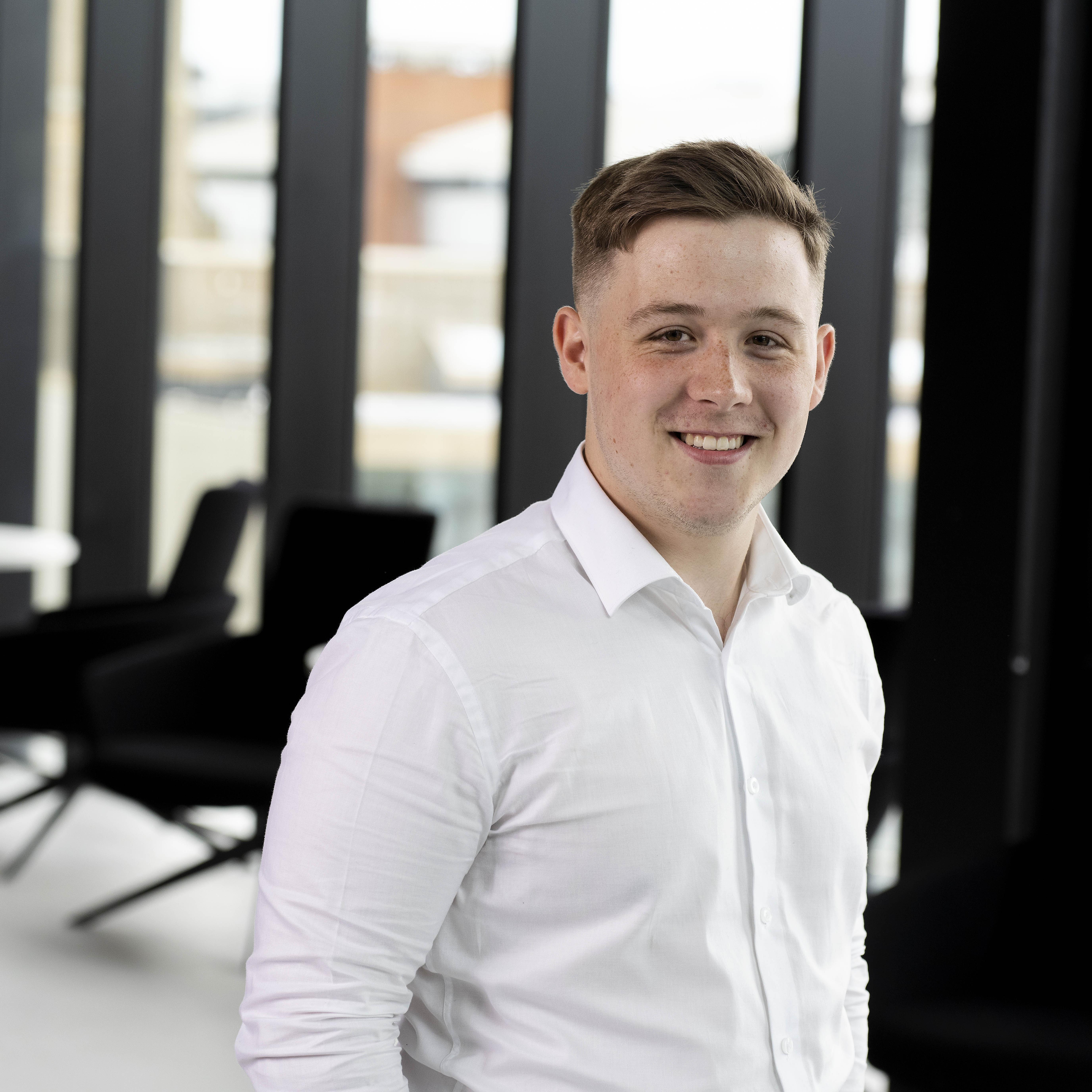 Rory Pagan smiling in a white shirt