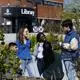 Students standing in a group outside the library building