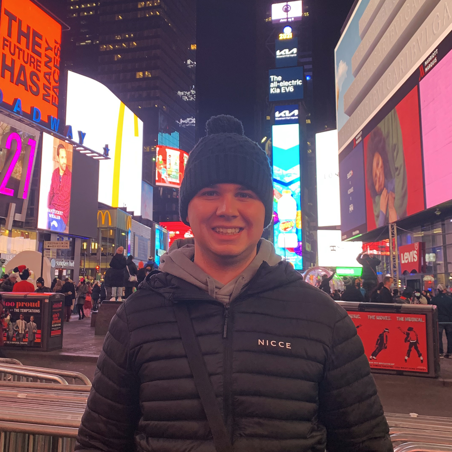 Sports Journalism student Adam Proud standing in Times Square, New York City