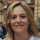 A profile image of Master's student Christina Laporda with a city street in the background.