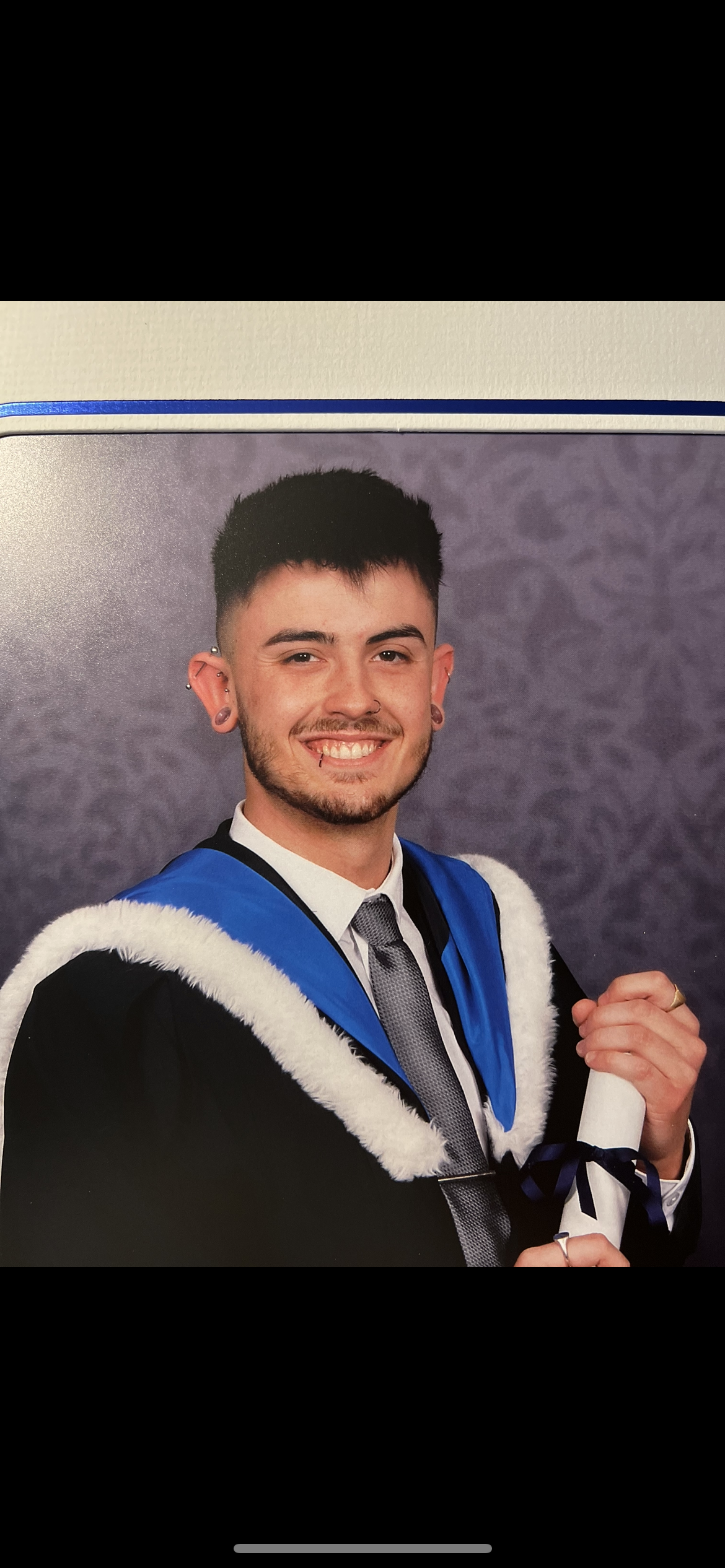 Ethan Westmorland in graduation robe