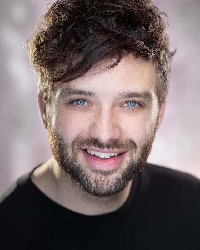 James Lloyd- Skinner in a black shirt and smile