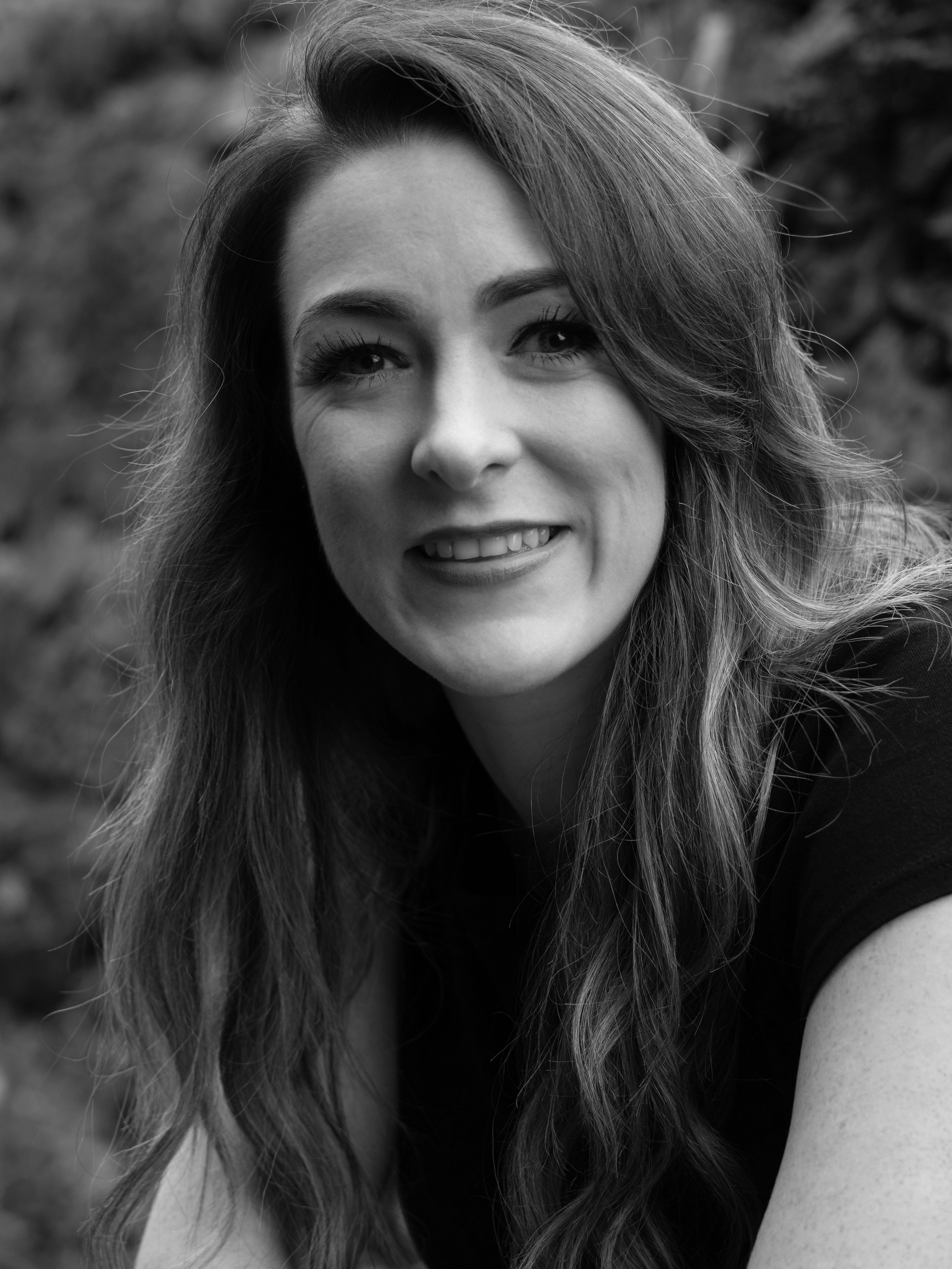 Jenny Williams in a top smiles at camera