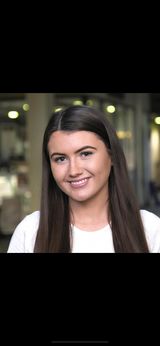 Mairead Croly in a white top smiles at camera