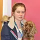 trinity rogers in a coat with her dog