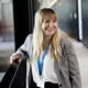 Member of staff at UCLan smiling and looking away from the camera.