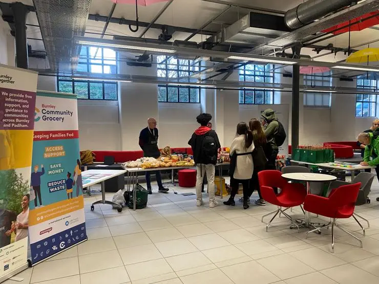 Students chatting to Community Grocery