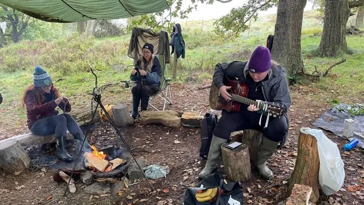 Students sat around the campfire