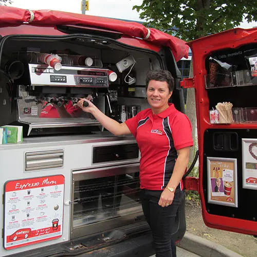 Anne-Marie Craven smiling beside her Cafe2U franchise.