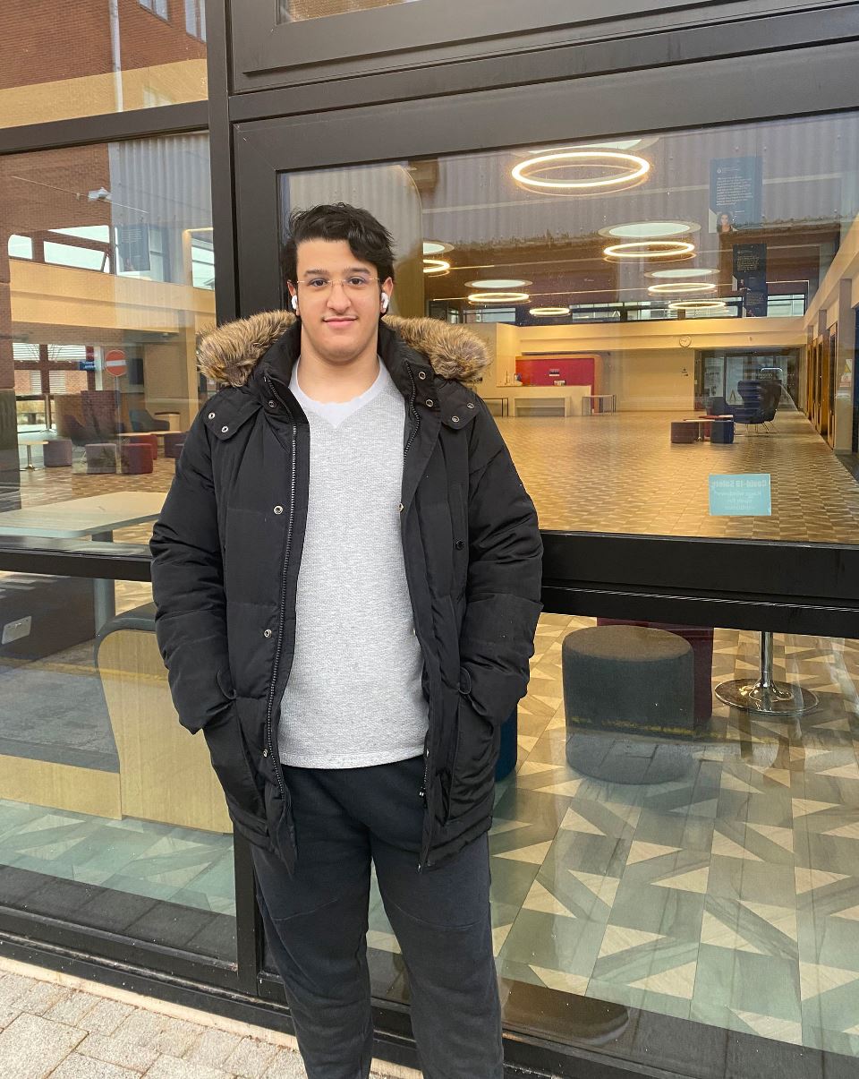 Bader in a grey top and jacket