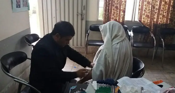 Researcher collecting blood sample