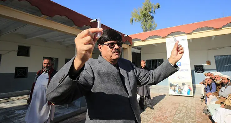 Professor Mukhtiar Zaman demonstrating the (small) amount of blood that will be collected.