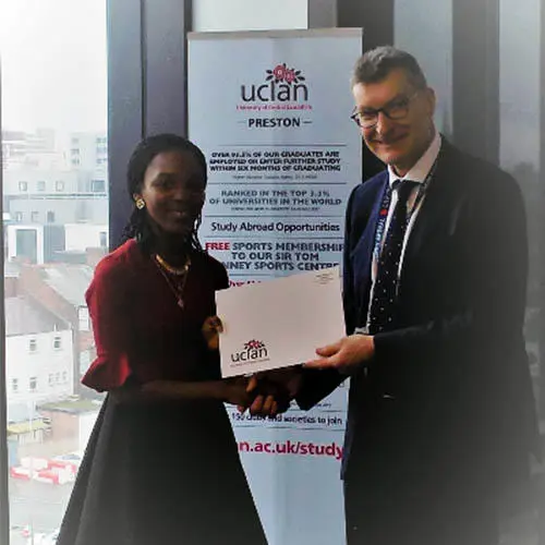 Joan receiving her scholarship award from Vice Chancellor Professor Graham Baldwin.