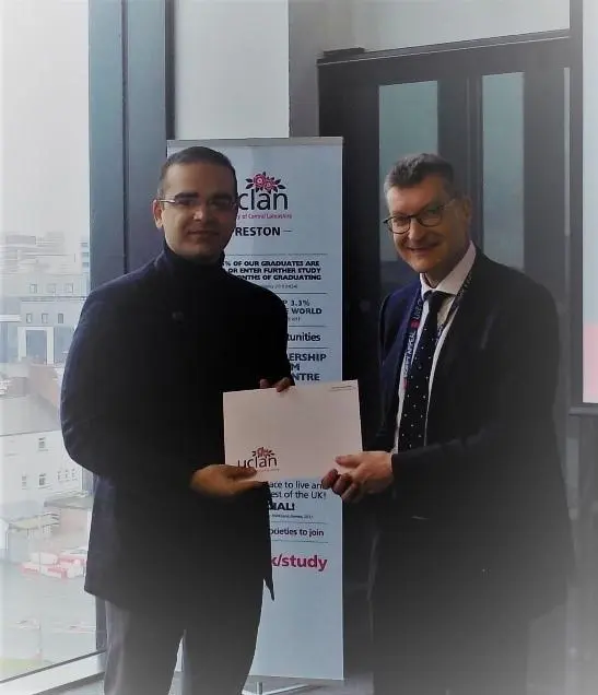 Ghulam receiving his scholarship award from Vice Chancellor Professor Graham Baldwin