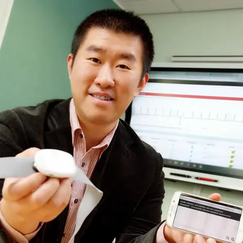 Dr Li Guo with the portable electrocardiogram (ECG) monitor