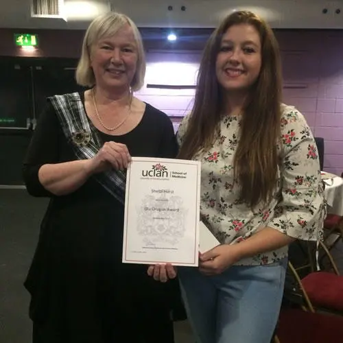 Shelbi Hurst (right) receives her certificate
