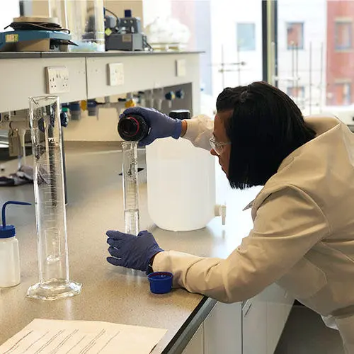Technician Terri Blohm measuring the chemical compound