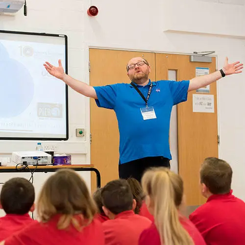 Professor Robert Walsh with children at a workshop