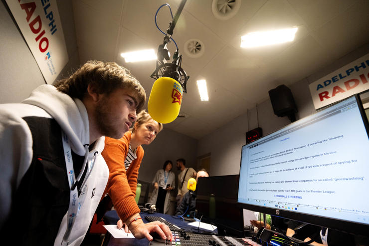Taylor Griffiths from Bolton 6th Form reads a news bulletin in the radio studio